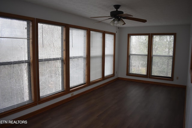 unfurnished sunroom with ceiling fan