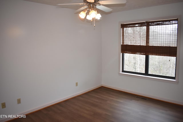 unfurnished room featuring dark hardwood / wood-style flooring and ceiling fan