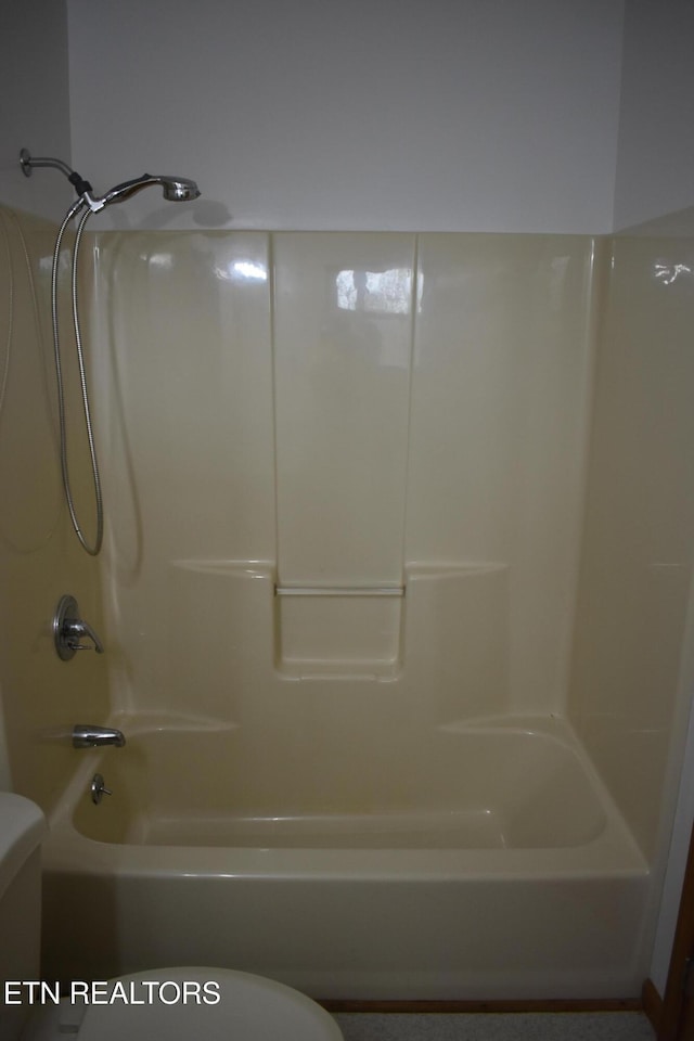 bathroom with toilet and tub / shower combination