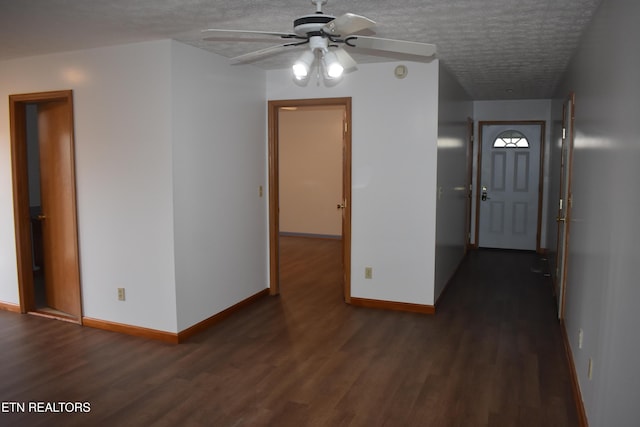 interior space featuring ceiling fan, dark hardwood / wood-style flooring, and a textured ceiling