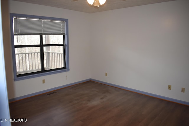 empty room featuring a textured ceiling, dark hardwood / wood-style floors, and ceiling fan