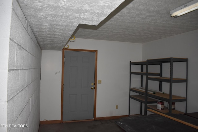 basement featuring a textured ceiling