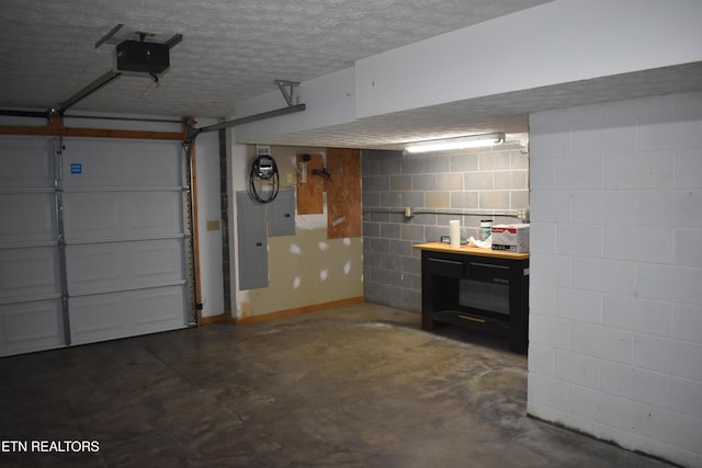 garage featuring electric panel and a garage door opener