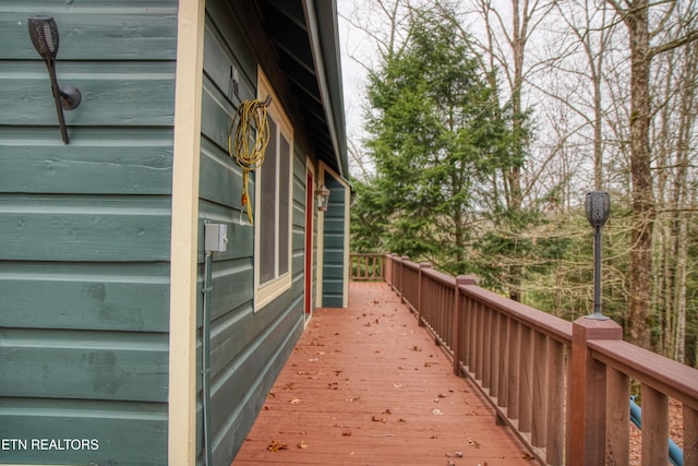 view of property exterior featuring a wooden deck