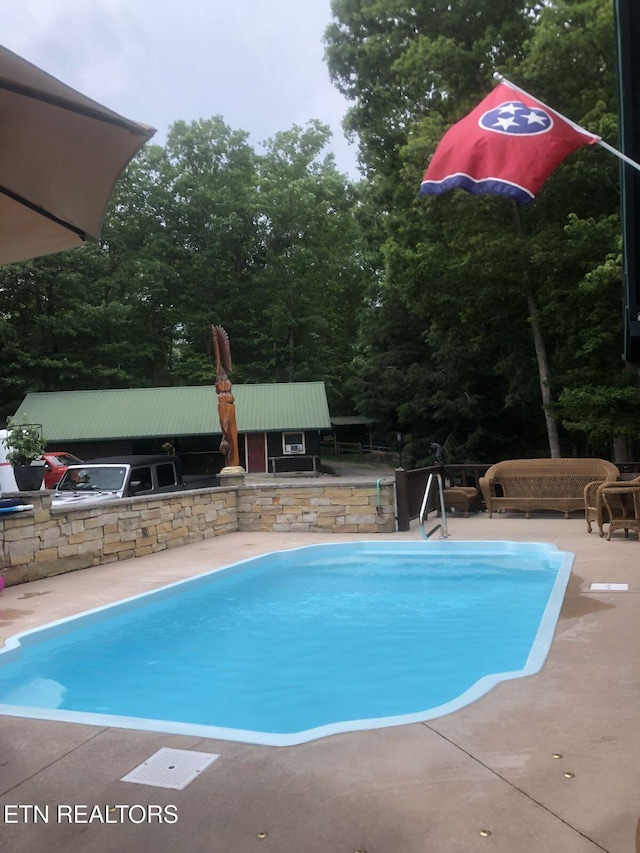 view of swimming pool featuring a patio area