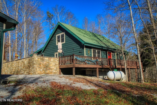 back of property featuring a wooden deck