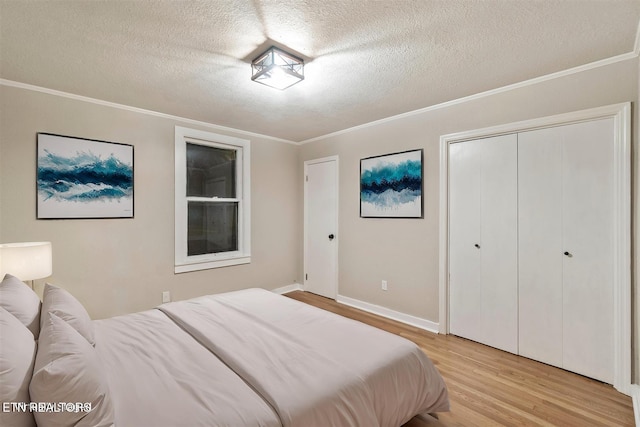 bedroom featuring crown molding, a textured ceiling, and light hardwood / wood-style flooring