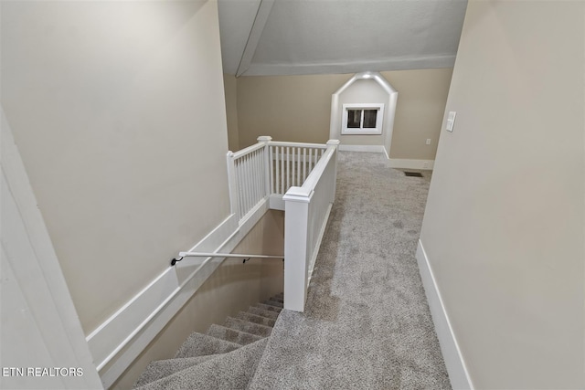 stairs featuring carpet flooring and vaulted ceiling