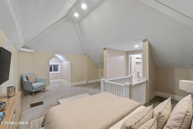 bedroom with light carpet, a textured ceiling, and lofted ceiling