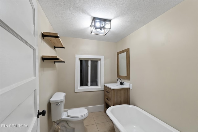 bathroom featuring vanity, tile patterned floors, a washtub, toilet, and a textured ceiling