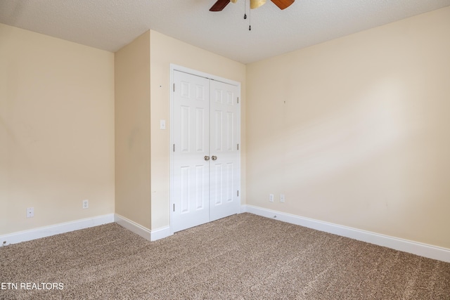 unfurnished bedroom featuring ceiling fan, a closet, carpet, and a textured ceiling