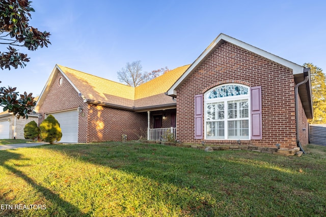 view of front facade with a front yard and a garage