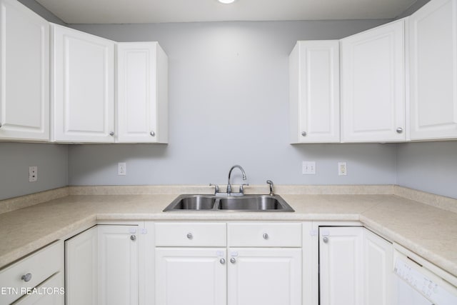 kitchen featuring dishwasher, sink, and white cabinets