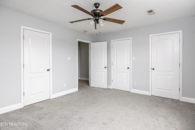 unfurnished bedroom featuring light carpet and ceiling fan