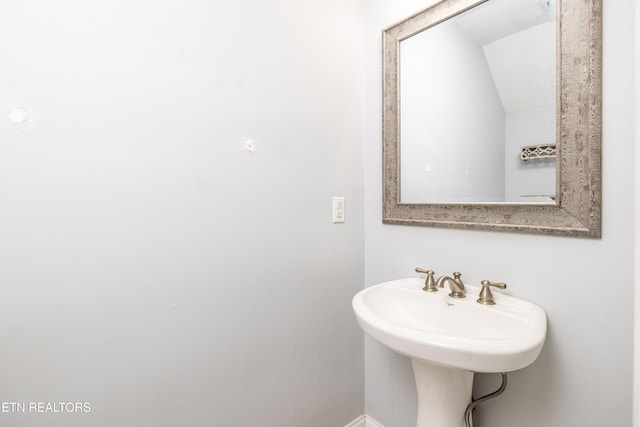 bathroom featuring vaulted ceiling