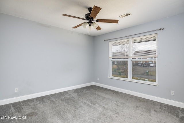 spare room featuring carpet and ceiling fan