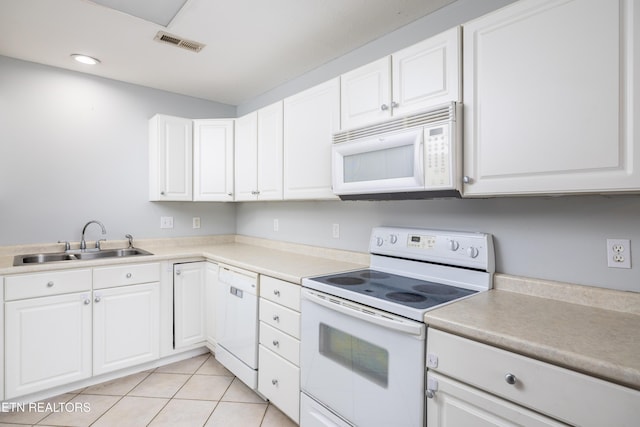 kitchen with white appliances, white cabinetry, and sink