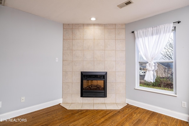 room details featuring a fireplace and wood-type flooring