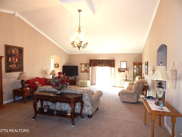 carpeted living room with ornamental molding, high vaulted ceiling, and an inviting chandelier