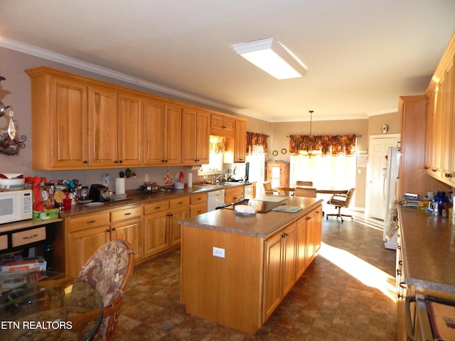 kitchen featuring crown molding, a center island, hanging light fixtures, and white appliances