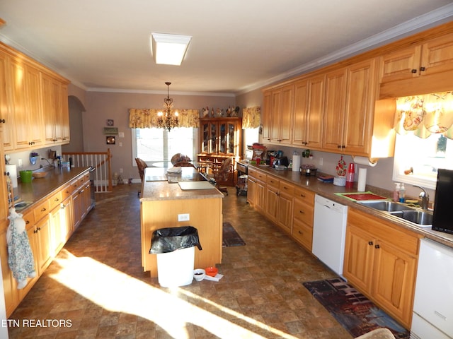 kitchen featuring a center island, sink, white dishwasher, pendant lighting, and a chandelier