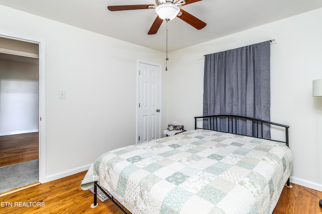 bedroom featuring hardwood / wood-style floors and ceiling fan