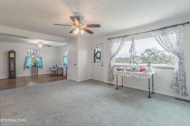 foyer with wood-type flooring and ceiling fan