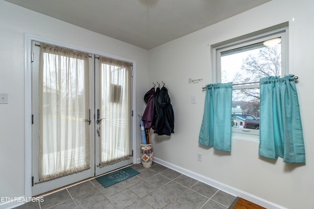 doorway to outside with tile patterned floors and french doors