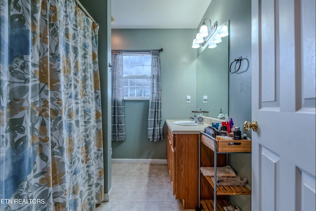 bathroom with tile patterned flooring, a shower with curtain, and vanity