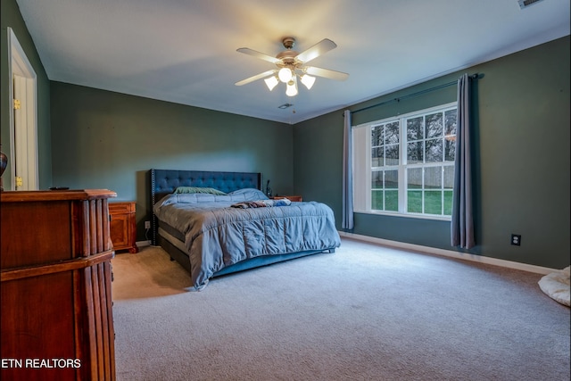 bedroom featuring ceiling fan and light colored carpet