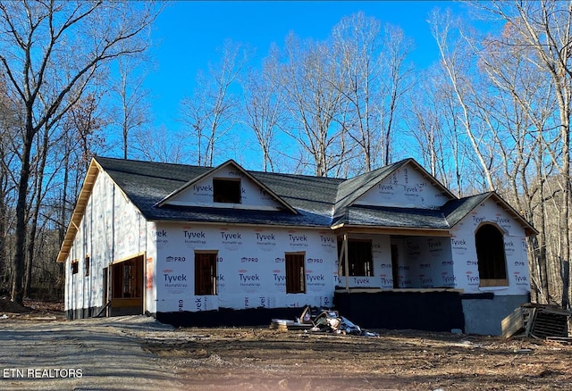 unfinished property featuring cooling unit and covered porch