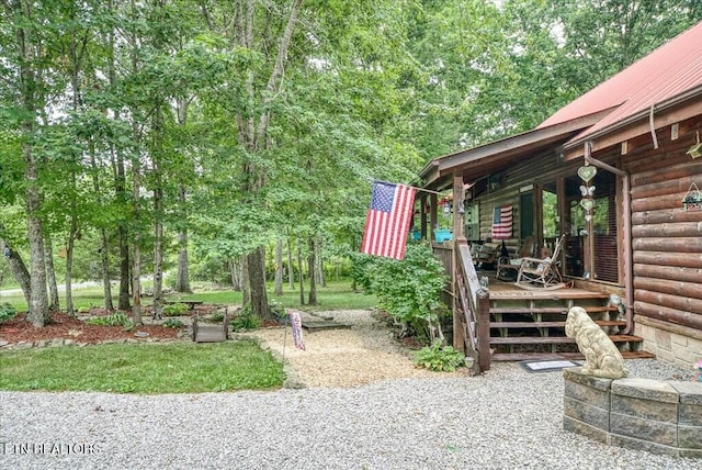 view of yard with covered porch