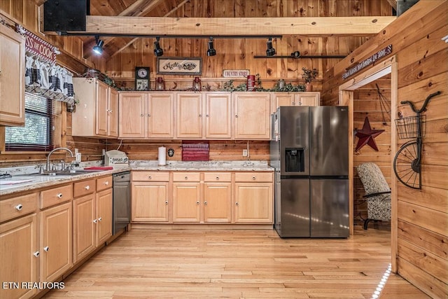 kitchen featuring beam ceiling, wooden walls, and stainless steel appliances