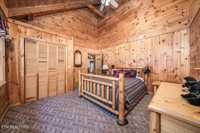 carpeted bedroom with beam ceiling, wooden walls, a closet, and high vaulted ceiling