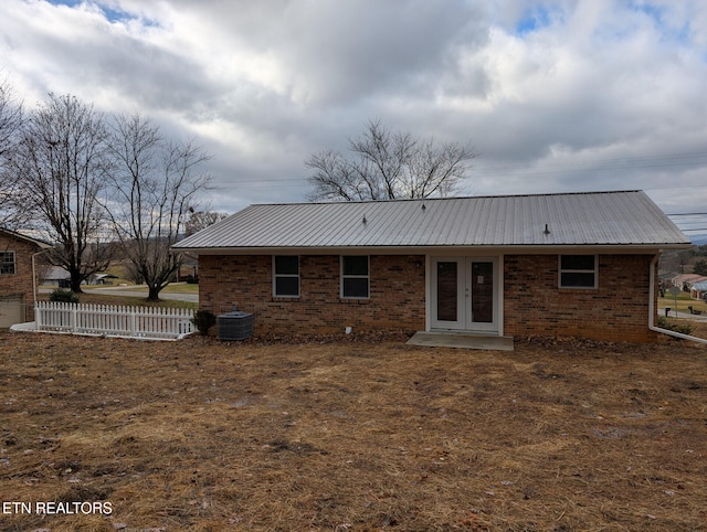 rear view of house featuring central AC and french doors