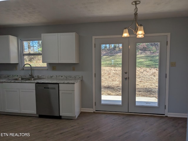 kitchen with pendant lighting, dishwasher, white cabinetry, and sink