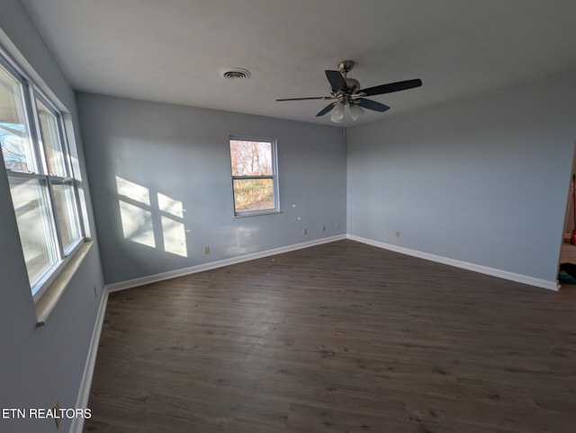 spare room with ceiling fan and dark hardwood / wood-style floors