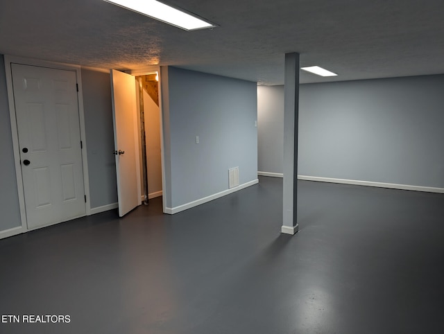 basement featuring a textured ceiling