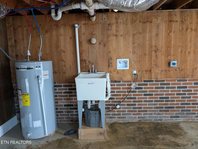 utility room with electric water heater and sink