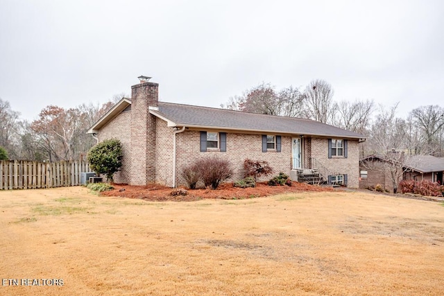 view of front of home with central AC and a front lawn