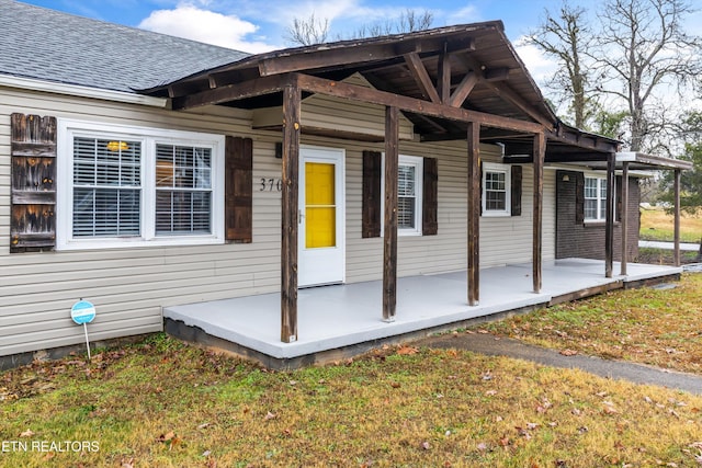 property entrance with a lawn