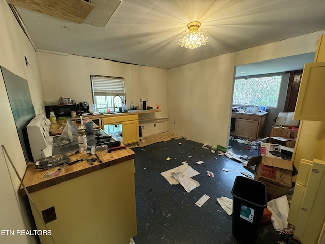 office space featuring plenty of natural light, sink, and a chandelier