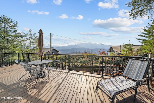 wooden deck featuring a mountain view