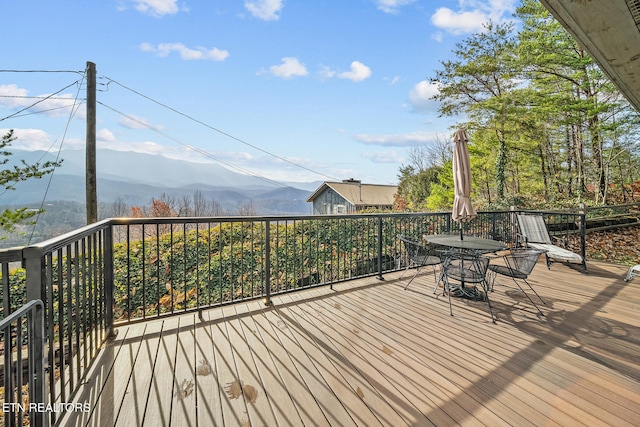 wooden deck with a mountain view