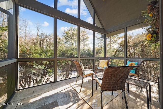 sunroom / solarium featuring lofted ceiling