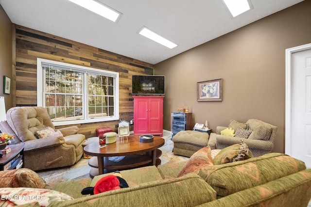 living room with wooden walls and lofted ceiling