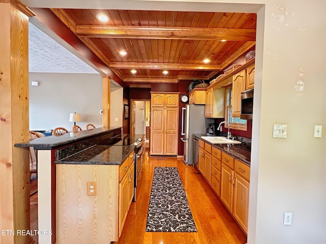 1132 E Foothills Dr, Gatlinburg, TN 37738 - kitchen featuring wooden ceiling with exposed beams, appliances with stainless steel finishes, a sink, light wood-style floors, and a breakfast bar