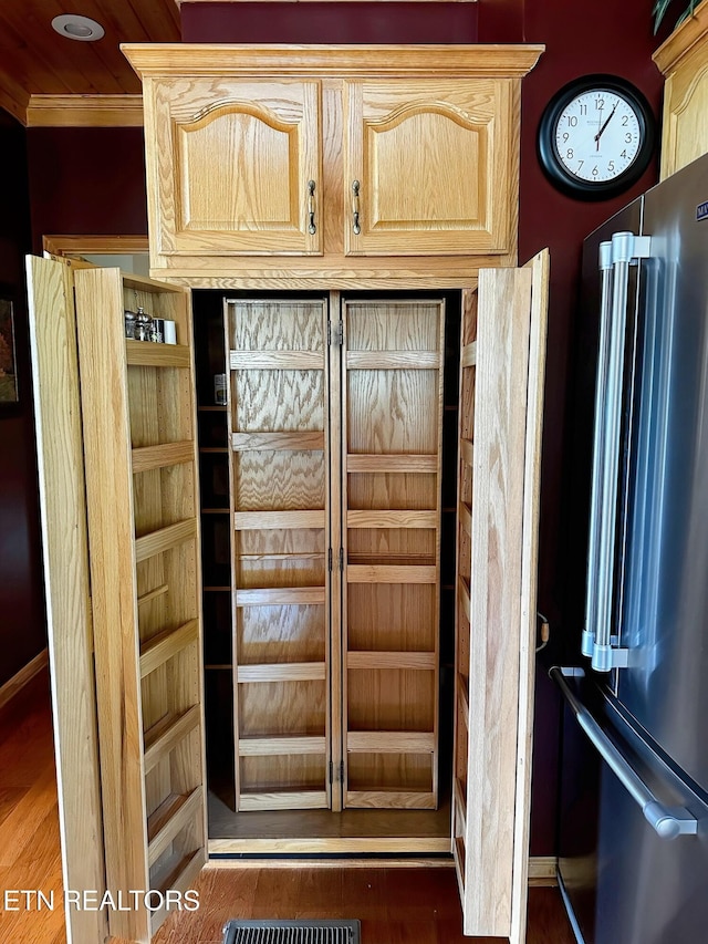 1132 E Foothills Dr, Gatlinburg, TN 37738 - detailed view of freestanding refrigerator, crown molding, wood finished floors, and baseboards