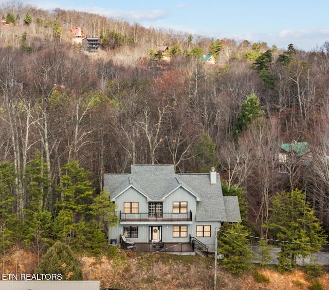1132 E Foothills Dr, Gatlinburg, TN 37738 - back of house featuring a balcony, a forest view, and a chimney
