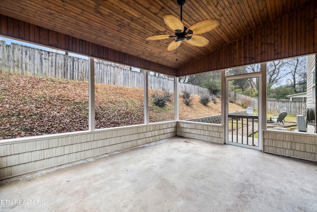 unfurnished sunroom with vaulted ceiling and ceiling fan